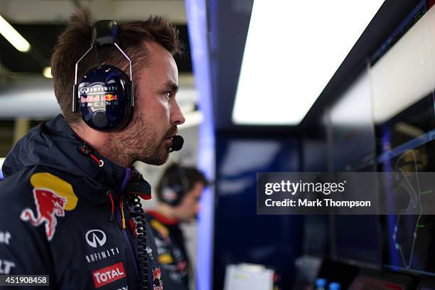 Infiniti Red Bull Racing Race Engineer Simon Rennie works in the garage during day two of testing at Silverstone Circuit on July 9, 2014 in...