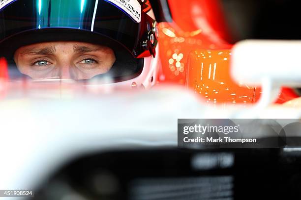 Max Chilton of Great Britain and Marussia sits in his car in the garage during day two of testing at Silverstone Circuit on July 9, 2014 in...