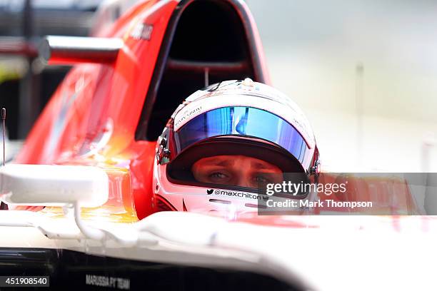 Max Chilton of Great Britain and Marussia sits in his car in the garage during day two of testing at Silverstone Circuit on July 9, 2014 in...