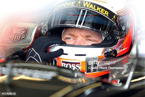 Kevin Magnussen of Denmark and McLaren sits in his car in the garage during day two of testing at Silverstone Circuit on July 9, 2014 in Northampton,...