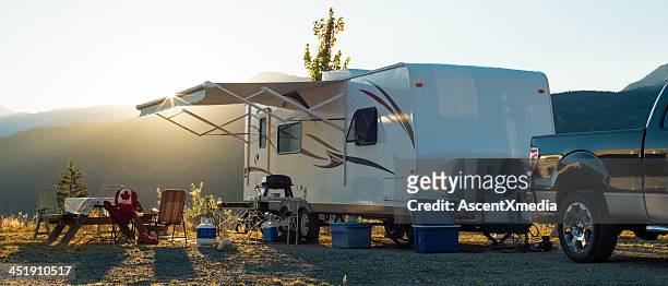 white recreational vehicle parked up at sunset - campervan stock pictures, royalty-free photos & images