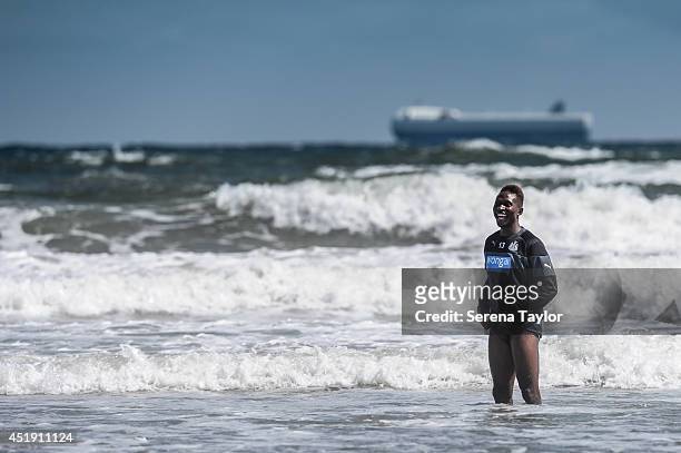 Newcastle player Mapou Yanga-Mbiwa cools in the ocean during a Newcastle United Training Session at the Longsands beach in Tynemouth on July 09 in...