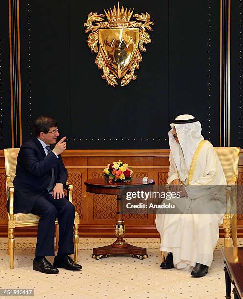 Turkish FM Ahmet Davutoglu meets with Khalifa ibn Salman Al Khalifa the PM of Bahrain in Manama on November 25, 2013.