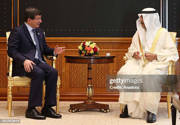 Turkish FM Ahmet Davutoglu meets with Khalifa ibn Salman Al Khalifa the PM of Bahrain in Manama on November 25, 2013.