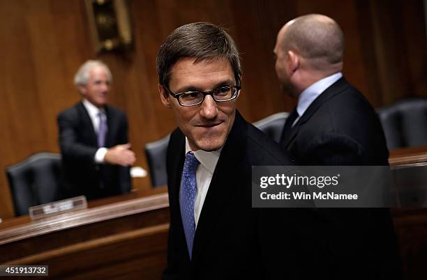 Assistant Secretary of Defense Derek Chollet prepares to testify before the Senate Foreign Relations Committee during a hearing July 9, 2014 in...