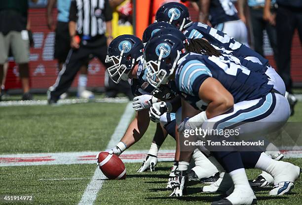 Jeff Keeping of the Toronto Argonauts lines up before snapping the ball during CFL game action against the Saskatchewan Roughriders on July 5, 2014...