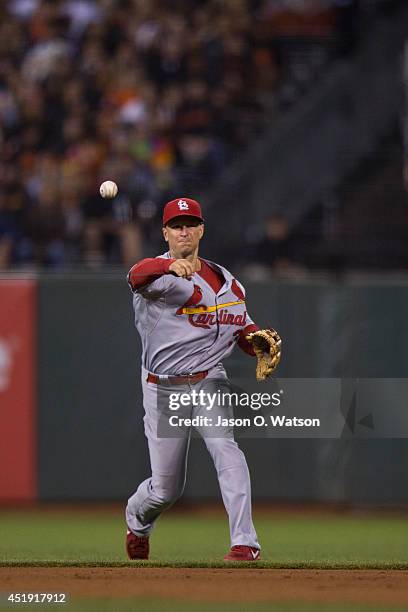 Mark Ellis of the St. Louis Cardinals throws to first base after fielding a ground ball hit off the bat of Tyler Colvin of the San Francisco Giants...