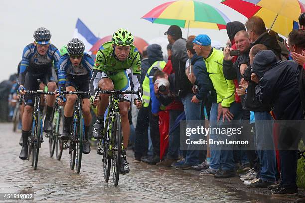 Kristijan Koren of Slovenia and Cannondale leads two Netapp riders as he enters the final sections of cobbles during the fifth stage of the 2014 Tour...