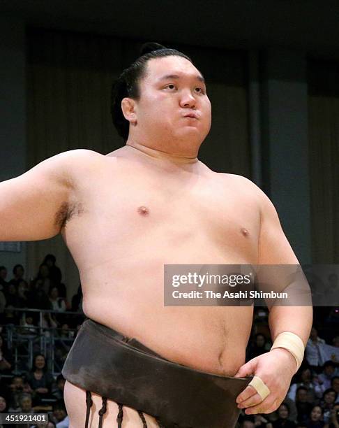 Mongolian yokozuna Hakuho, whose real name is Mnkhbatyn Davaajargal looks on during day fourteen of the Grand Sumo Kyushu Tournament at Fukuoka...