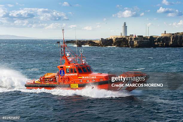 Picture taken on November 25, 2013 shows a Spanish coastguard vessel arriving at Tarifa's harbour after Spanish emergency services rescued 17...