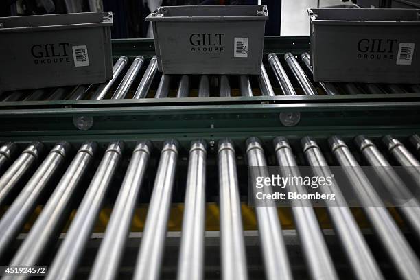 Buckets move down a conveyor belt as online orders for luxury fashion items and home goods are fulfilled at the Gilt Groupe Inc. Distribution center...