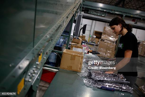 Receiver Traci Henderson packages cutlery at the Gilt Groupe Inc. Distribution center in Shepherdsville, Kentucky, U.S., on Wednesday, July 9, 2014....