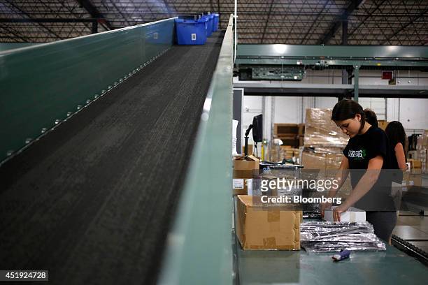 Receiver Traci Henderson packages cutlery at the Gilt Groupe Inc. Distribution center in Shepherdsville, Kentucky, U.S., on Wednesday, July 9, 2014....