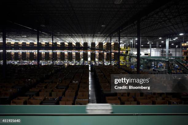 Bucket moves down a conveyor belt as online orders for luxury fashion items and home goods are fulfilled at the Gilt Groupe Inc. Distribution center...