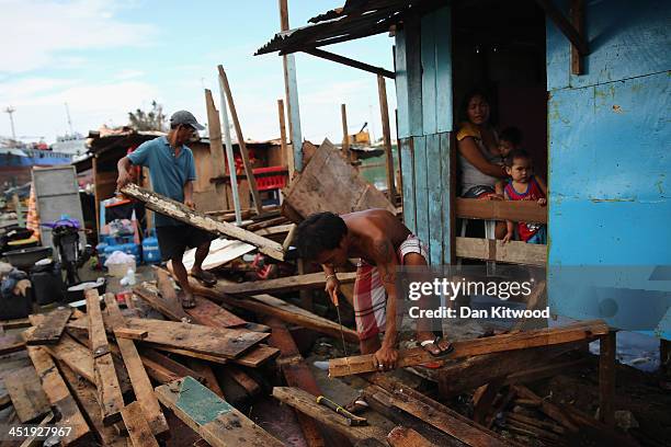 Family begin to rebuild their home on the shoreline where several tankers ran aground in Tacloban on November 17, 2013 in Leyte, Philippines. Typhoon...