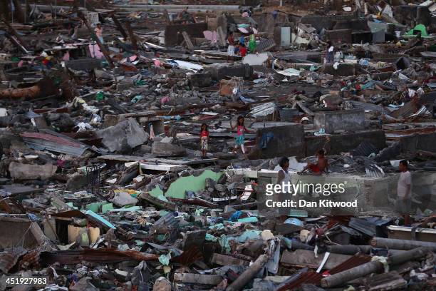 People look through the debris in a demolished shanty in Tacloban on November 16, 2013 in Leyte, Philippines. Typhoon Haiyan which ripped through...