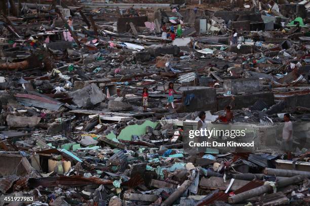 People look through the debris in a demolished shanty in Tacloban on November 16, 2013 in Leyte, Philippines. Typhoon Haiyan which ripped through...