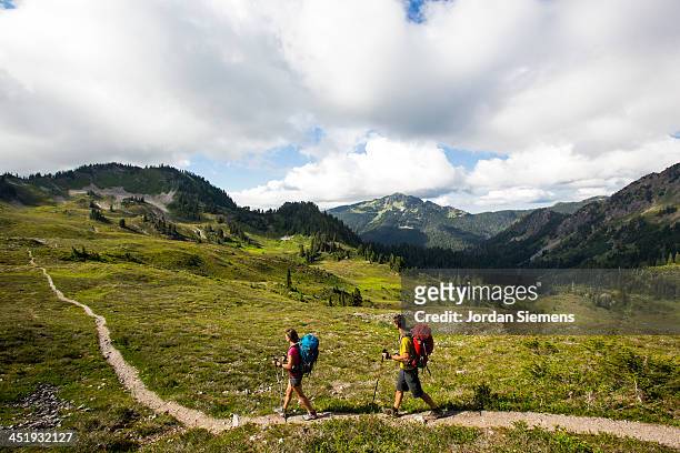 man and woman hiking outdoors - turismo ecológico fotografías e imágenes de stock