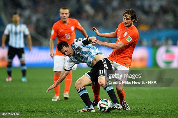 Lionel Messi of Argentina and Daley Blind of the Netherlands compete for the ball during the 2014 FIFA World Cup Brazil Semi Final match between...