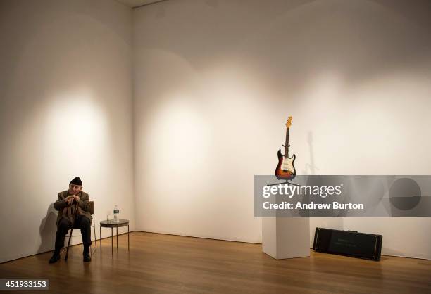 George Wein, founder of the Newport Folk and Jazz Festivals, sits next to the Fender Stratocaster electric guitar played by musician Bob Dylan on...