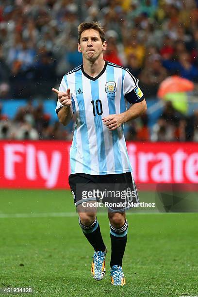 Lionel Messi of Argentina celebrates scoring a goal during a penalty shootout during the 2014 FIFA World Cup Brazil Semi Final match between the...