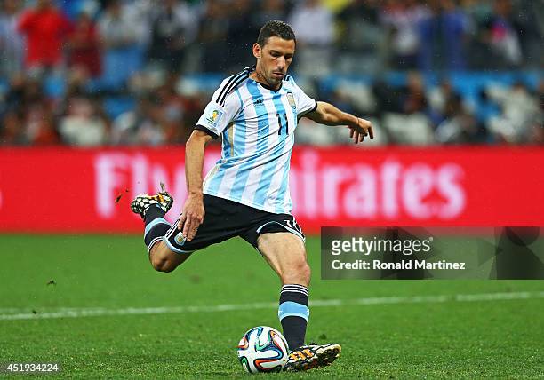 Maxi Rodriguez of Argentina shoots and scores his penalty kick in a shootout to defeat the Netherlands during the 2014 FIFA World Cup Brazil Semi...