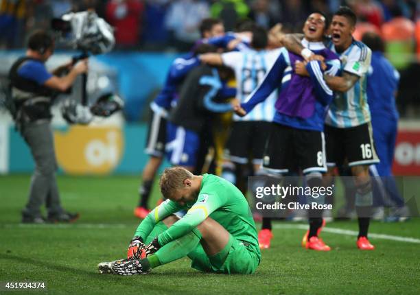 Jasper Cillessen of the Netherlands reacts after being defeated by Argentina in a penalty shootout as Enzo Perez and Marcos Rojo of Argentina...