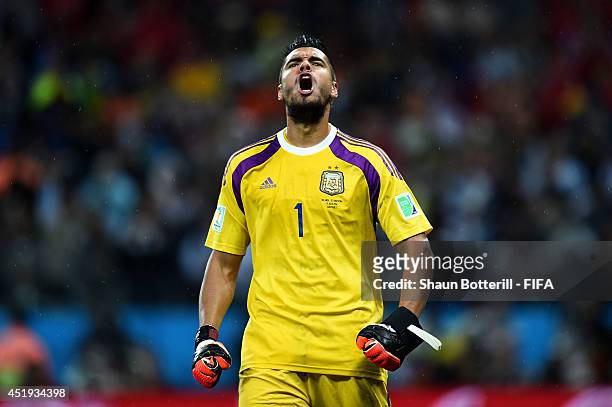 Sergio Romero of Argentina reacts after saving a penalty by Ron Vlaar of the Netherlands in the penalty shootout during the 2014 FIFA World Cup...
