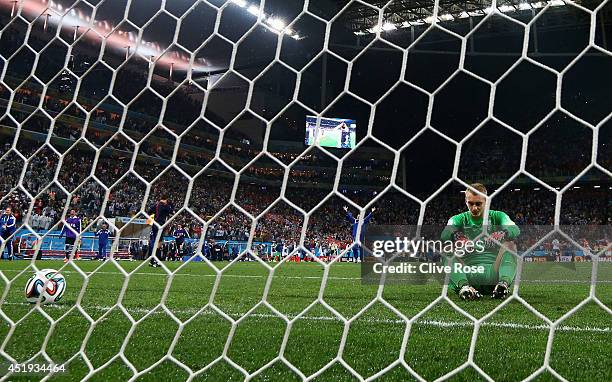 Jasper Cillessen of the Netherlands sits on the pitch after failing to save the penalty kick of Maxi Rodriguez of Argentina during the 2014 FIFA...