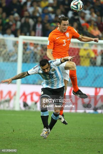 Stefan De Vrij of the Netherlands heads the ball over Ezequiel Lavezzi of Argentina during the 2014 FIFA World Cup Brazil Semi Final match between...