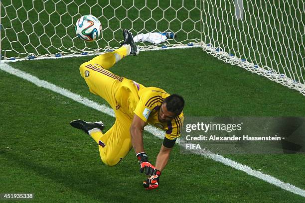 Sergio Romero of Argentina saves the penalty kick of Ron Vlaar in a shootout during the 2014 FIFA World Cup Brazil Semi Final match between the...