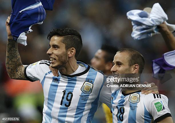 Argentina's forward Rodrigo Palacio and Argentina's midfielder Ricky Alvarez celebrate after the semi-final football match between Netherlands and...