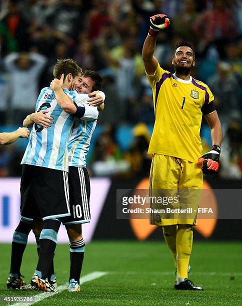 Sergio Romero , Lionel Messi and Lucas Biglia of Argentina celebrate the win on penalties after the 2014 FIFA World Cup Brazil Semi Final match...