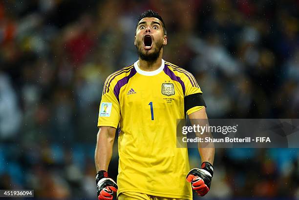 Sergio Romero of Argentina reacts after stopping the penalty kick by Wesley Sneijder of the Netherlands in the penalty shootout during the 2014 FIFA...