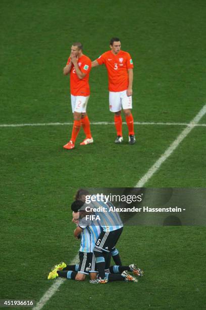 Javier Mascherano of Argentina celebrates with his team mates Ezequiel Garay and Lucas Biglia defeating the Netherlands in a shootout whilst Ron...