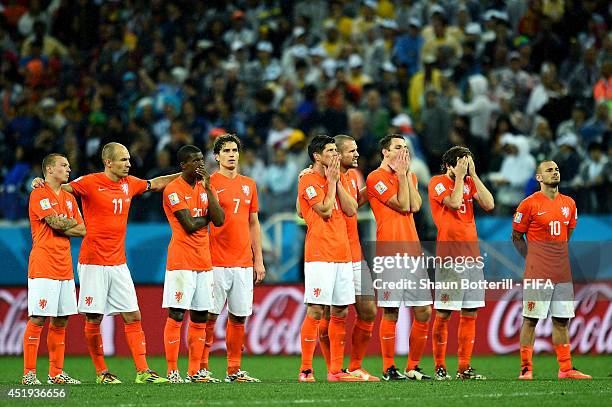 Players of the Netherlands watch the penalty shootout during the 2014 FIFA World Cup Brazil Semi Final match between Netherlands and Argentina at...