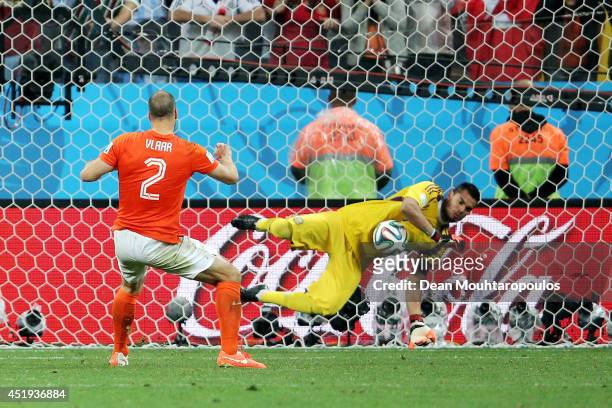 Sergio Romero of Argentina saves the penalty kick of Ron Vlaar of the Netherlands in a shootout during the 2014 FIFA World Cup Brazil Semi Final...