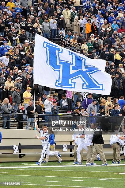 Cheerleader runs with the flag of the Kentucky Wildcats prior to a game against the Vanderbilt Commodores at Vanderbilt Stadium on November 16, 2013...