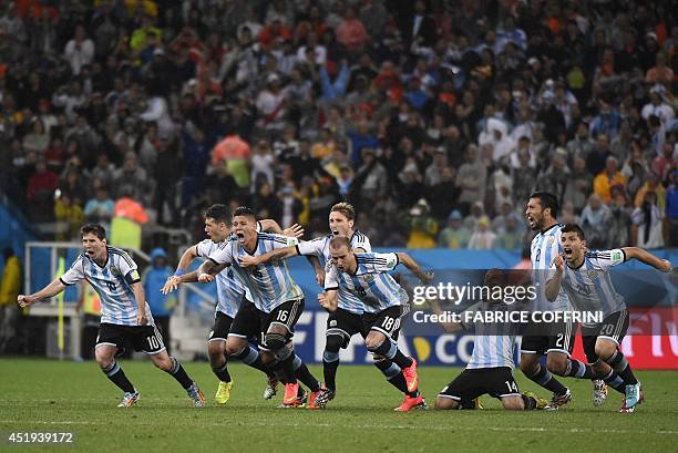 Argentina's team celebrates after winning their FIFA World Cup semi-final match against the Netherlands in a penalty shoot-out following extra time...