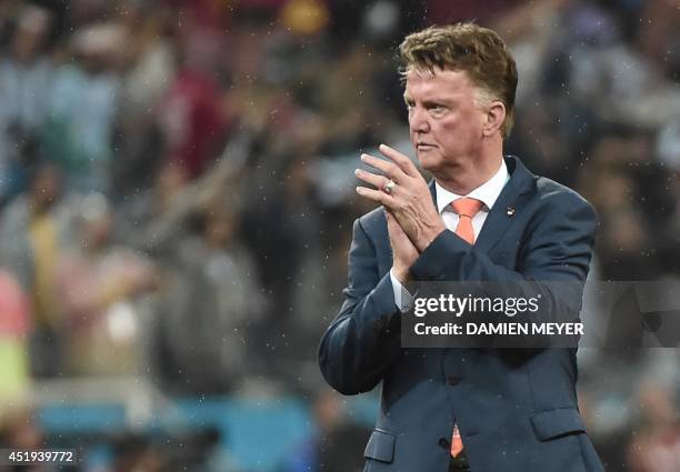 Netherlands' coach Louis van Gaal applauds after the semi-final football match between Netherlands and Argentina of the FIFA World Cup at The...