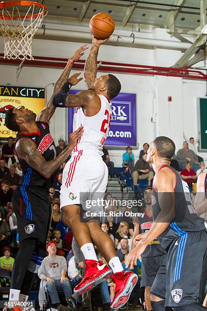 Romero Osby of the Maine Red Claws shoots over Gary Forbes of the Springfield Armor on November 22, 2013 at the Portland Expo in Portland, Maine....