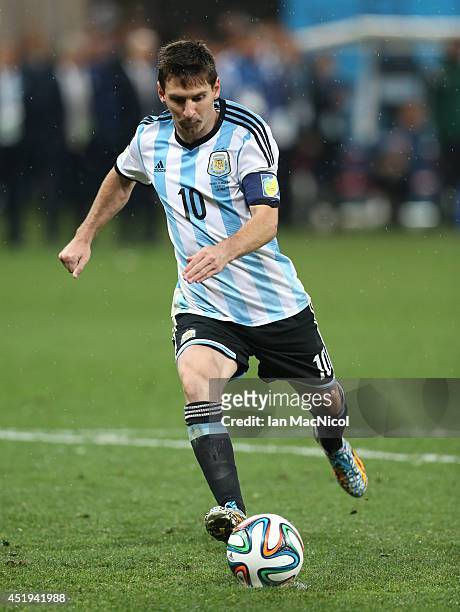 Lionel Messi of Argentina scores a penalty during the 2014 FIFA World Cup Brazil Semi Final match between Netherlands and Argentina at The Arena de...