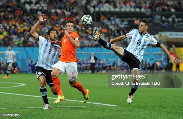 Robin Van Persie of the Netherlands in action with Ezequiel Garay and Martin Dimichelis of Argentina during the 2014 FIFA World Cup Brazil Semi Final...