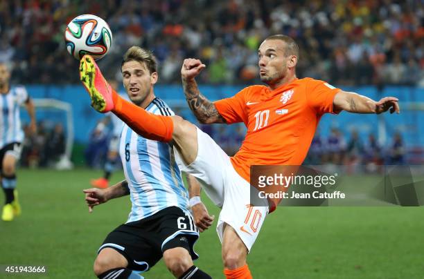 Lucas Biglia of Argentina and Wesley Sneijder of the Netherlands in action during the 2014 FIFA World Cup Brazil Semi Final match between the...