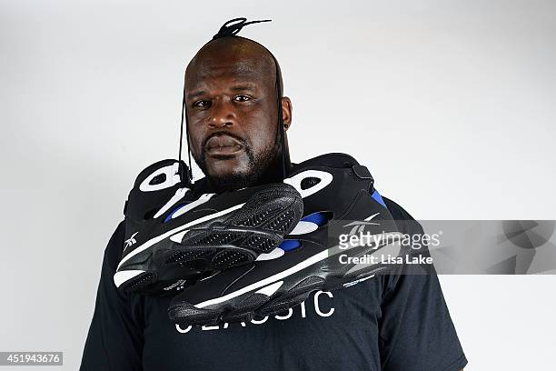 Former NBA basketball player Shaquille O'Neal poses with Reebok sneakers at the Reebok Classic Breakout at Philadelphia University on July 9, 2014 in...