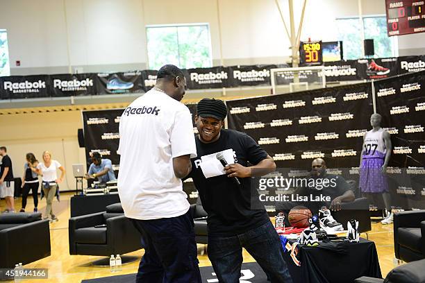 Former NBA player Shawn Kemp greets host Sway Calloway at the Reebok Classic Breakout Classic Rap Roundable at Philadelphia University on July 9,...