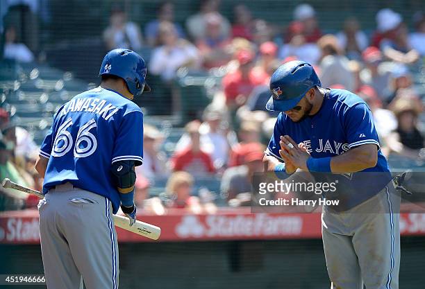 Melky Cabrera of the Toronto Blue Jays celebrates his run with Munenori Kawasaki to take a 7-6 lead during the sixth inning at Angel Stadium of...
