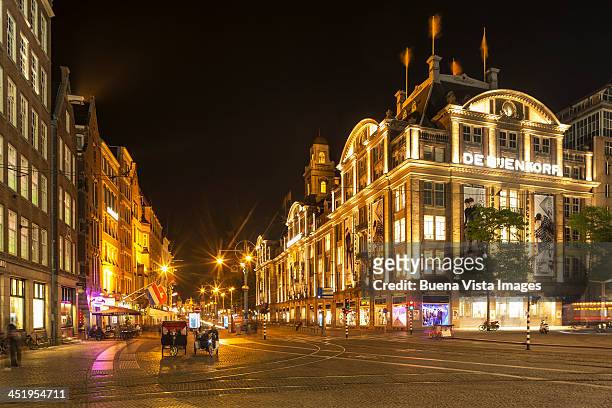 illuminated buildings in dam square - dam square stock pictures, royalty-free photos & images