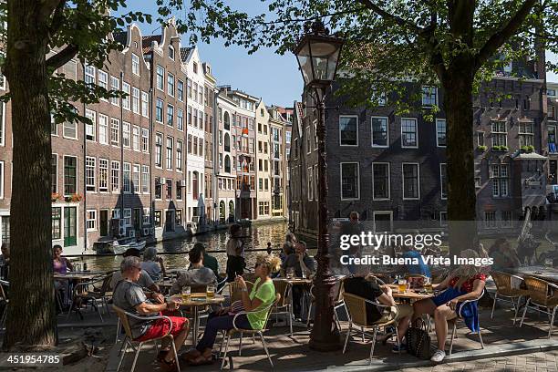 people in an outside cafe in amsterdam - amsterdam cafe stock pictures, royalty-free photos & images