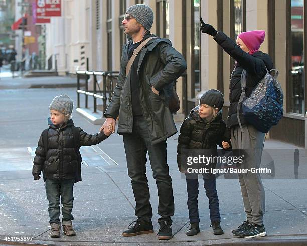 Naomi Watts and Liev Schreiber hail a taxi with their sons, Sasha Schreiber and Sammy Schreiber on November 25, 2013 in New York City.